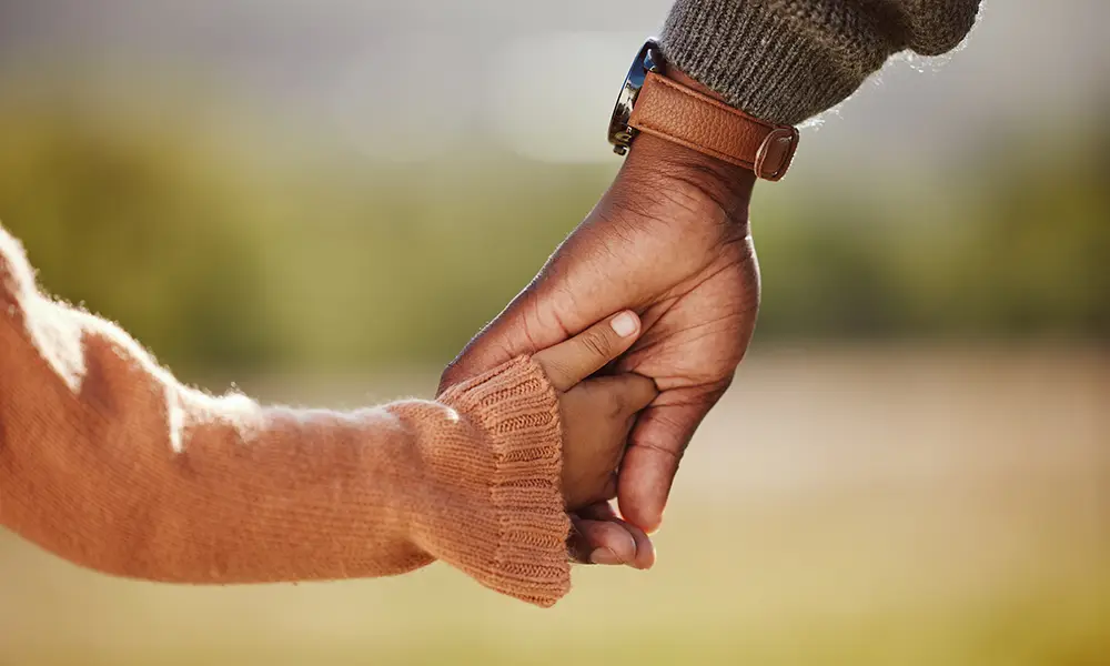 young child holding hands of parent or guardian - child custody collinsville il