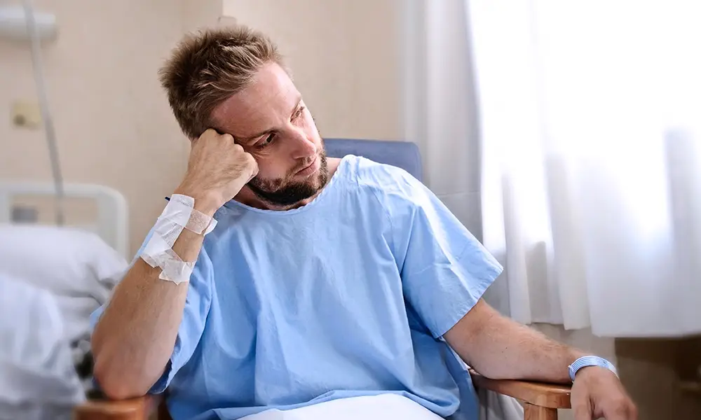 hospitalized man upset due to personal injury from a car accident